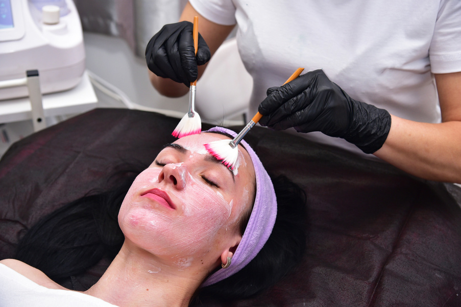 The beautician performs a facial cleansing procedure. Facial care, mask, scrub. Hardware facial cleansing. Skin rejuvenation and beauty.