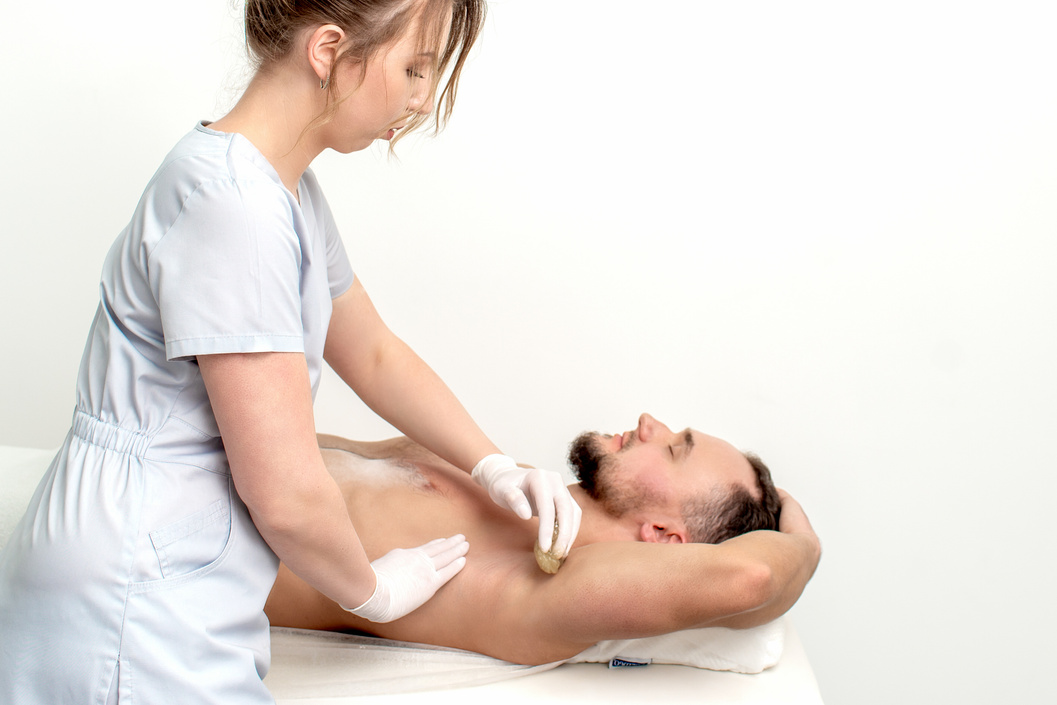 Young Man Receiving Waxing Underarm