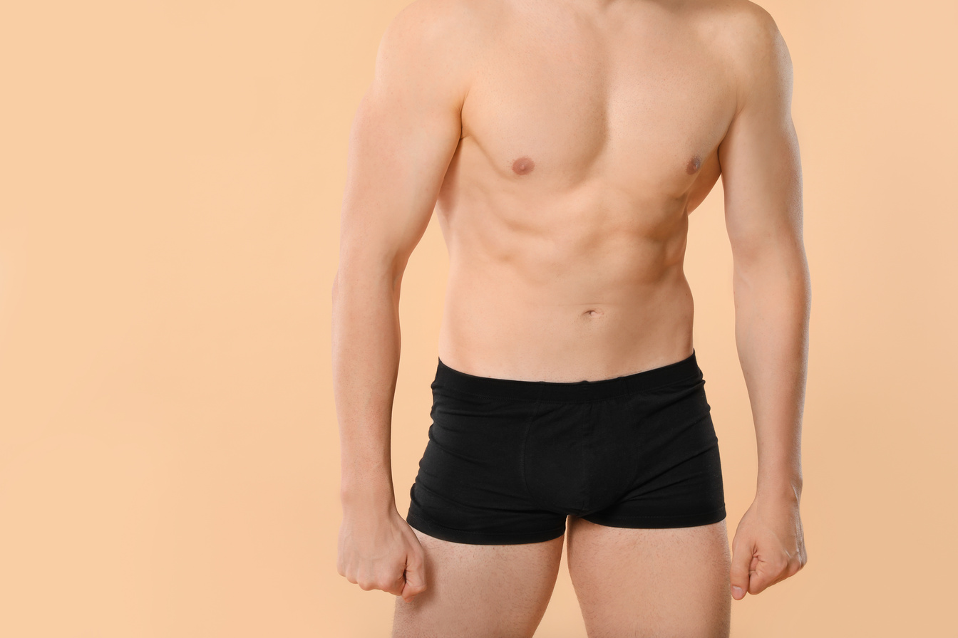 Man in Underwear on Color Background