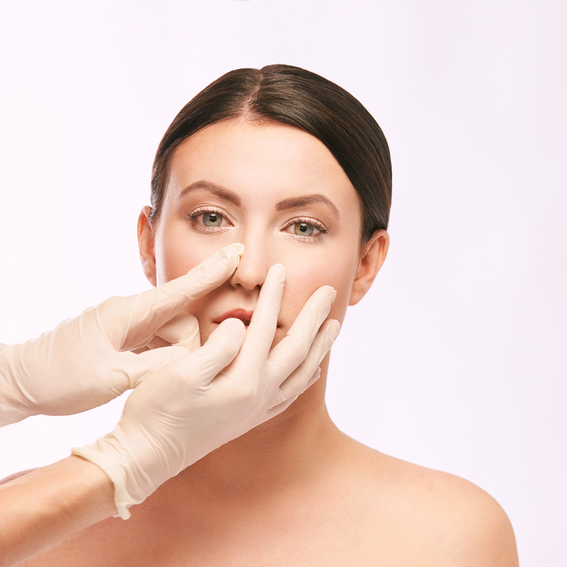 Hands with Gloves Pinching a Woman's Nose 