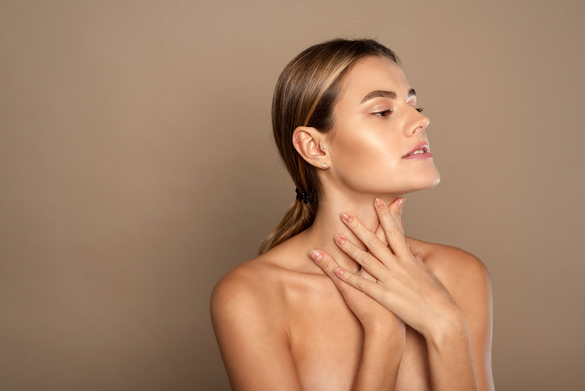 Lovely Young Woman Touches Her Neck. Beautiful Woman Cares for the Skin Neck. Heath and Beauty Concept